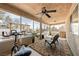 Relaxing screened-in patio area with comfortable seating, ceiling fan, and backyard views at 5481 Lincolnwood Ct, Pahrump, NV 89061