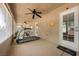 Covered patio features a treadmill, exercise bike, ceiling fans, and access to the backyard at 5481 Lincolnwood Ct, Pahrump, NV 89061