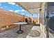 Backyard with large patio cover, neutral colored exterior, and table at 5667 Foxglove Field St, Las Vegas, NV 89130