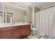 Bathroom with shower, wood vanity, and neutral colored walls at 5667 Foxglove Field St, Las Vegas, NV 89130