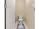 Powder room features white toilet and modern rug on ceramic tile flooring at 5667 Foxglove Field St, Las Vegas, NV 89130