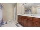 Bathroom with double sink vanity, ceramic floors, and neutral colored walls at 5667 Foxglove Field St, Las Vegas, NV 89130