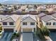 Two-story stucco home with a tile roof, two car garage, and desert landscaping at 5667 Foxglove Field St, Las Vegas, NV 89130