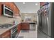 Gourmet kitchen featuring stainless steel appliances and rich wood cabinetry at 5667 Foxglove Field St, Las Vegas, NV 89130