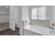 Bright bathroom featuring white bathtub and a view into a separate toilet room and walk-in closet at 5846 Bonita Rose St, Las Vegas, NV 89113