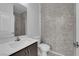 Modern bathroom with sleek vanity, toilet, and decorative tiled accent wall at 5846 Bonita Rose St, Las Vegas, NV 89113