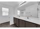 This spacious bathroom includes a double sink vanity, large mirror, and walk-in shower at 5846 Bonita Rose St, Las Vegas, NV 89113