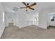 Upstairs common area boasting neutral carpeting, a ceiling fan, and multiple doorways to bedrooms at 5846 Bonita Rose St, Las Vegas, NV 89113