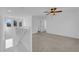 Upstairs view showcasing an open landing leading to a spacious carpeted bedroom with ceiling fan at 5846 Bonita Rose St, Las Vegas, NV 89113