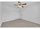 This empty bedroom features a ceiling fan, neutral carpet, light walls, and a closet at 5846 Bonita Rose St, Las Vegas, NV 89113