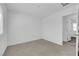 This empty bedroom has neutral carpet, light-colored walls, and an open doorway at 5846 Bonita Rose St, Las Vegas, NV 89113