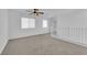 Carpeted upstairs area with ceiling fan and multiple windows, providing natural light and comfortable space at 5846 Bonita Rose St, Las Vegas, NV 89113