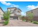 Charming two-story home boasts a well-manicured front yard, a gray two-car garage, and a neutral color scheme at 5846 Bonita Rose St, Las Vegas, NV 89113