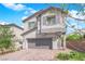 Charming two-story home boasts a well-manicured front yard, a gray two-car garage, and a neutral color scheme at 5846 Bonita Rose St, Las Vegas, NV 89113