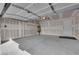 Spacious two-car garage featuring high ceilings, ample lighting, and convenient access door for easy entry at 5846 Bonita Rose St, Las Vegas, NV 89113
