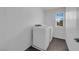 Bright laundry room features a side-by-side washer and dryer and a window for natural light at 5846 Bonita Rose St, Las Vegas, NV 89113