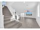 Bright living room with modern staircase and tile floors offers an open concept layout at 5846 Bonita Rose St, Las Vegas, NV 89113
