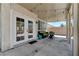 This back patio has double doors to the house and outdoor furniture with string lights overhead at 6013 Aqua Blue Ct, North Las Vegas, NV 89031