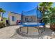 Backyard features a trampoline, patio, rock landscaping, and home exterior at 6013 Aqua Blue Ct, North Las Vegas, NV 89031