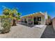 Backyard shows patio, rock landscaping, and home exterior under a blue sky at 6013 Aqua Blue Ct, North Las Vegas, NV 89031