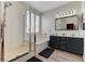This bathroom features a tub with shower, dark vanity, and bright lights at 6013 Aqua Blue Ct, North Las Vegas, NV 89031
