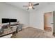 This bedroom features a ceiling fan, neutral carpet and paint, and an ensuite bathroom at 6013 Aqua Blue Ct, North Las Vegas, NV 89031
