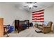 Cozy bedroom with a crib, rocking chair, and a playful striped curtain at 6013 Aqua Blue Ct, North Las Vegas, NV 89031