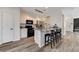 Modern kitchen with granite countertops, stainless steel appliances, and breakfast bar seating for casual dining at 6013 Aqua Blue Ct, North Las Vegas, NV 89031