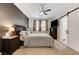 Comfortable bedroom with a ceiling fan, dark accent wall, and a barn-style closet door at 6013 Aqua Blue Ct, North Las Vegas, NV 89031