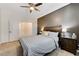 Comfortable bedroom with a ceiling fan and bedside tables with lamps at 6013 Aqua Blue Ct, North Las Vegas, NV 89031