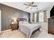 Cozy main bedroom with neutral tones, ceiling fan, and carpeted floors, creating a relaxing retreat at 6013 Aqua Blue Ct, North Las Vegas, NV 89031