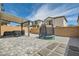 Well-maintained backyard with patio cover, brick walls, a trampoline and an outdoor grill at 6338 Selston Dr, North Las Vegas, NV 89081