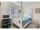 Bright bedroom with a distinctive white four-poster bed and dedicated desk area at 6338 Selston Dr, North Las Vegas, NV 89081