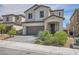 Attractive two-story home with a brick-paved driveway, a two-car garage, and desert landscaping at 6338 Selston Dr, North Las Vegas, NV 89081
