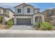 Charming two-story home featuring a two-car garage, landscaped yard, and a welcoming front porch at 6338 Selston Dr, North Las Vegas, NV 89081