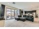 Spacious living room with a sectional sofa seamlessly connected to the open kitchen area at 6338 Selston Dr, North Las Vegas, NV 89081