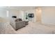 Spacious living room featuring neutral carpeting and a comfortable couch with a chaise lounge at 6338 Selston Dr, North Las Vegas, NV 89081