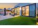 Lush backyard with artificial turf, outdoor kitchen, dining, and seating, great for entertaining at 650 Scenic Cliff Dr, Henderson, NV 89012