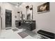 Elegant bathroom with dual vanities, pendant lighting, marble countertops, and a glass-enclosed shower at 650 Scenic Cliff Dr, Henderson, NV 89012