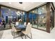 Contemporary dining room with modern light fixture, sleek table, and large glass doors at 650 Scenic Cliff Dr, Henderson, NV 89012