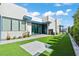 Modern house exterior with artificial turf, stone pathway, and bright blue door at 650 Scenic Cliff Dr, Henderson, NV 89012