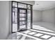 Bright foyer with modern door and window combination and sleek tile flooring at 650 Scenic Cliff Dr, Henderson, NV 89012