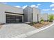 Modern home featuring a unique glass-paneled garage door and desert landscaping at 650 Scenic Cliff Dr, Henderson, NV 89012
