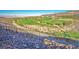 Scenic view of a lush green golf course surrounded by desert landscape and mountains at 650 Scenic Cliff Dr, Henderson, NV 89012