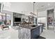 Spacious kitchen and living room with island, stainless appliances, and modern fireplace at 650 Scenic Cliff Dr, Henderson, NV 89012