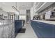 Stylish kitchen with marble countertops, shelving, and sleek blue cabinets at 650 Scenic Cliff Dr, Henderson, NV 89012
