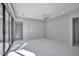 Open living room with light grey walls, white tile flooring and large windows at 650 Scenic Cliff Dr, Henderson, NV 89012