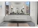 Modern bathroom with floating double vanity, wall-mounted lights and hillside views at 650 Scenic Cliff Dr, Henderson, NV 89012