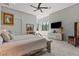 Spacious main bedroom with stylish decor, modern ceiling fan and decorative bedside tables at 650 Scenic Cliff Dr, Henderson, NV 89012