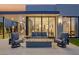 Inviting covered patio featuring comfortable seating and a cozy modern fire pit for outdoor enjoyment at 650 Scenic Cliff Dr, Henderson, NV 89012